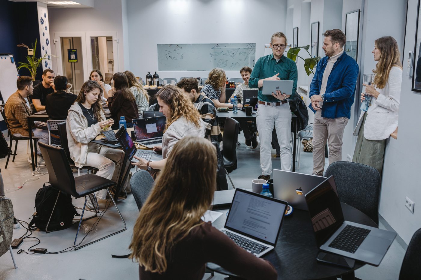 Participants listen to a teammate explain his idea at Product Build Day in Warsaw.