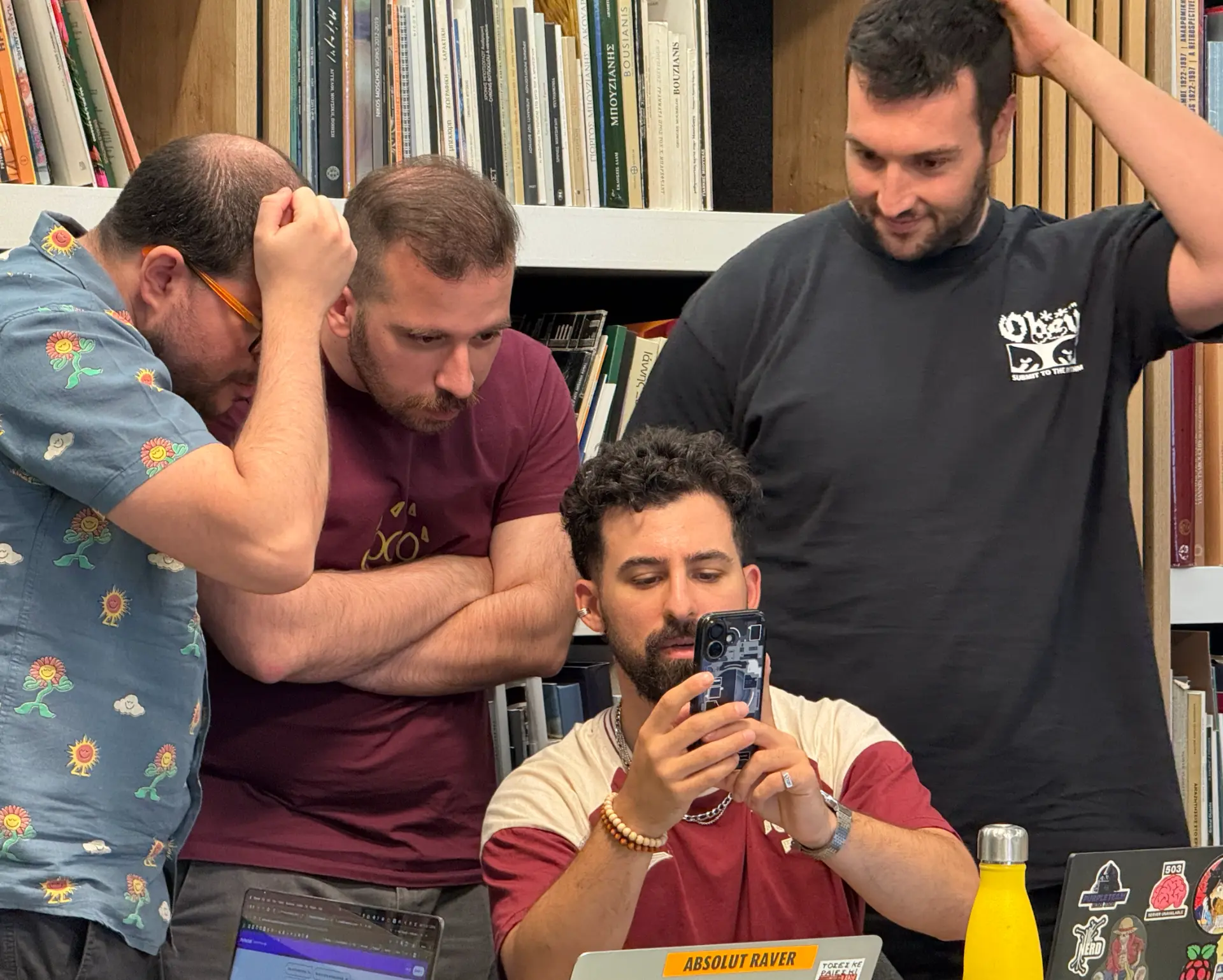 A team crowded around one screen reviewing their build
