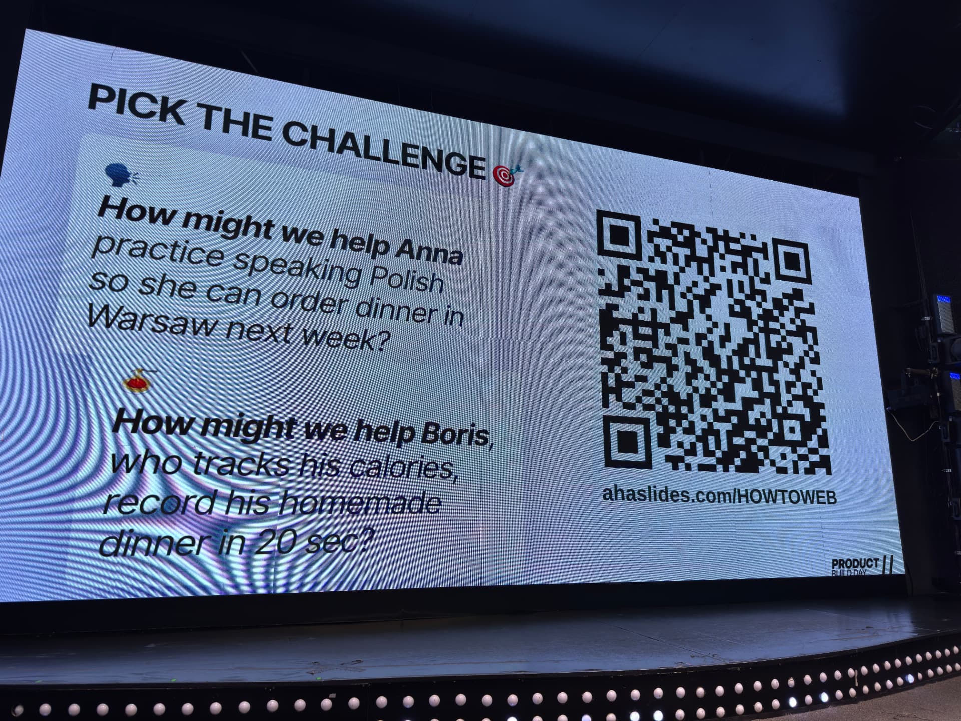 The two challenges of the session projected on the How to Web big screen, with the AhaSlides QR code